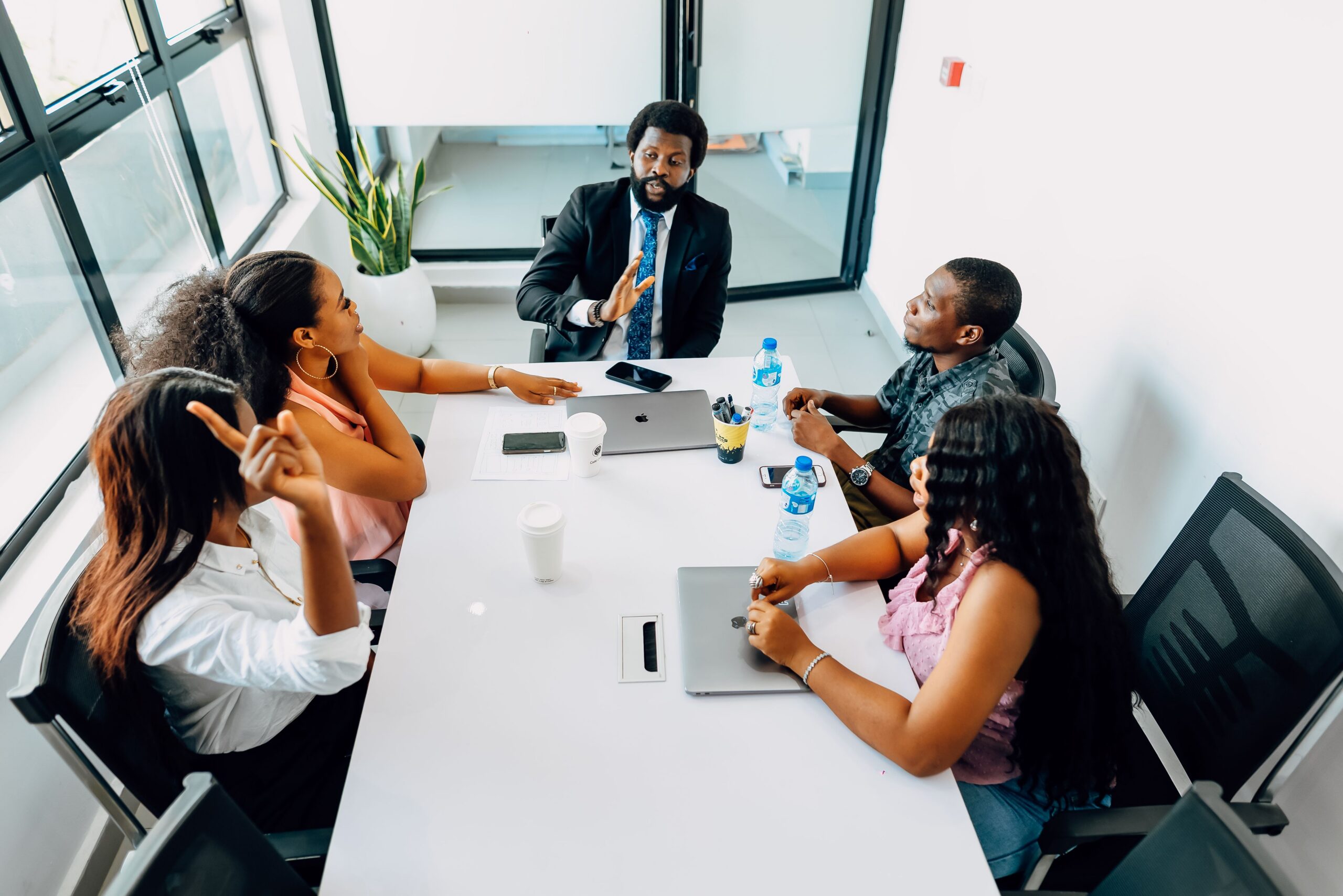Business professionals engage in a collaborative meeting in a bright Lagos office.